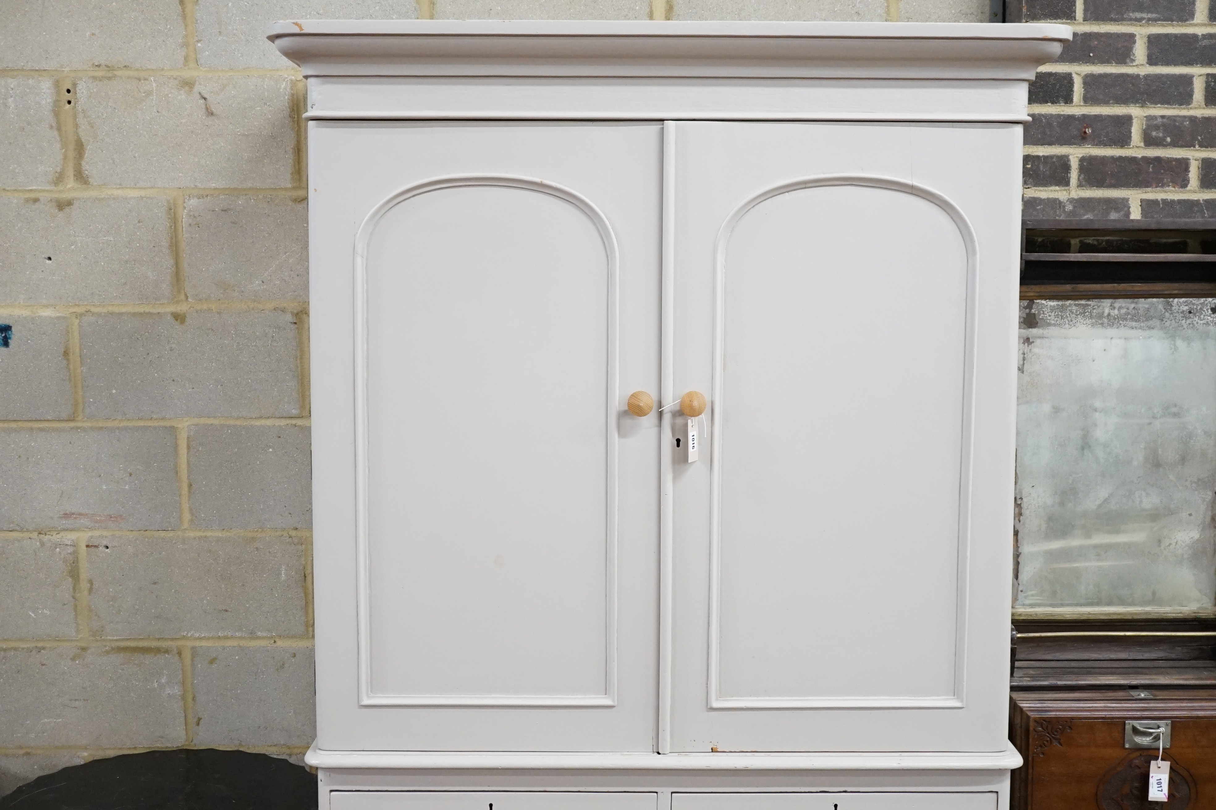 A Victorian later painted pine linen press, with two doors enclosing sliding trays, width 130cm, height 208cm